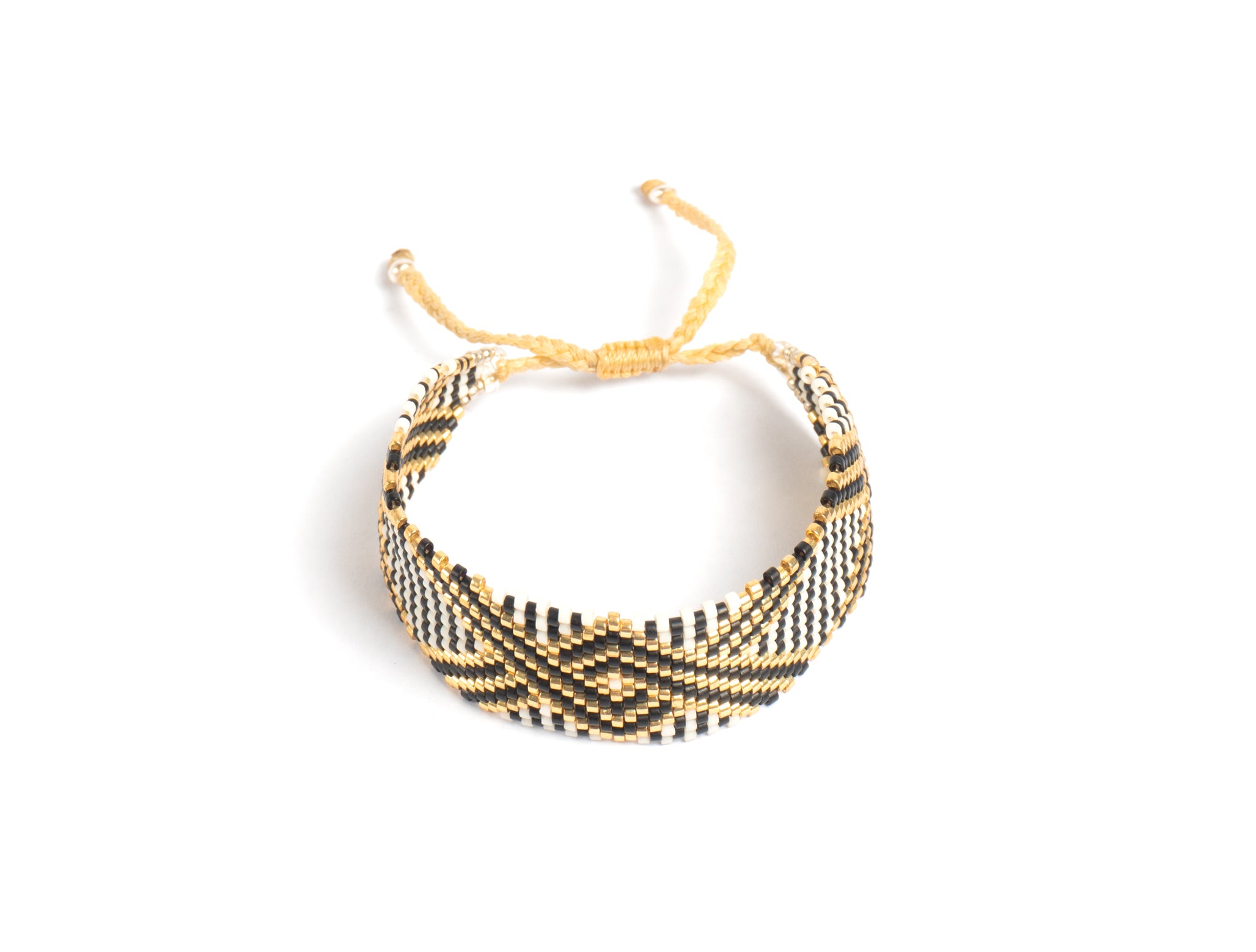 Pulsera Miyuki grande blanca lineas cruzadas negro oro