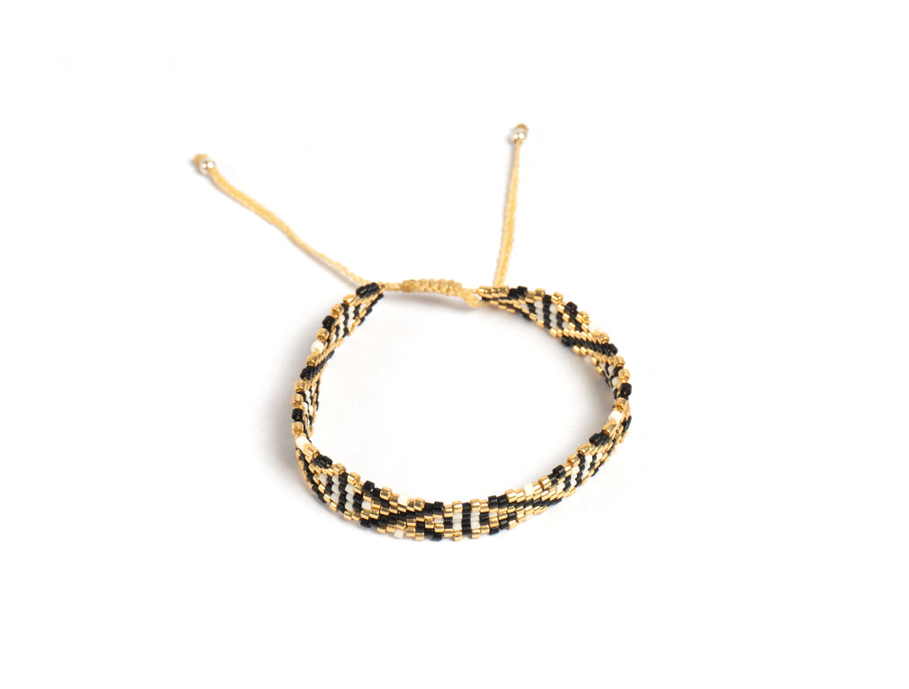 Pulsera Miyuki chica blanca lineas cruzadas negro dorado